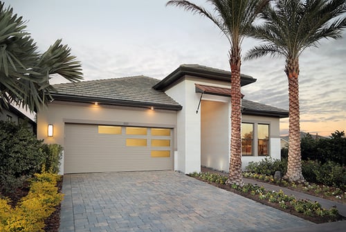 Clopay Modern Steel Collection garage door, grooved panel design with custom window layout. Narrow reed decorative glass. Desert tan paint. Double car