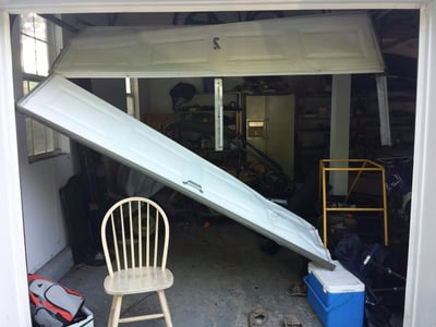 Garage Door Accidents & Why They Happen; damaged garage door 2.jpg