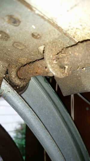 Old and rusty garage door roller