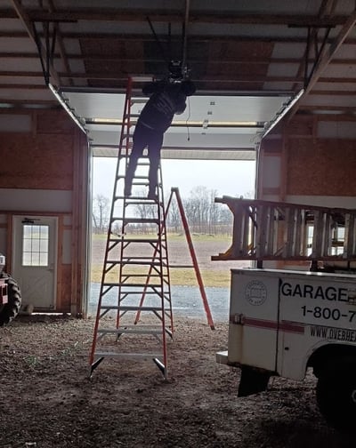 Tech repairing commercial overhead door in NJ