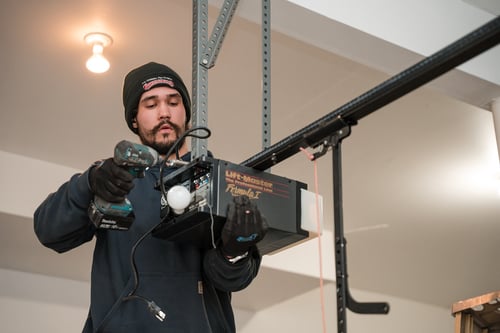 Technician Installing a New Garage Door Opener in New Jersey. Staff 1