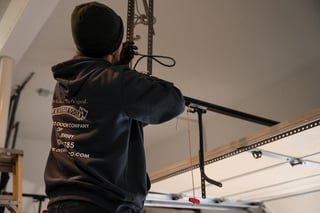 Technician Installing a New Garage Door Opener in New Jersey. Staff